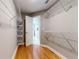 Walk-in closet featuring wood floors and wire shelving throughout at 1580 Commerce Dr # A8, Decatur, GA 30030