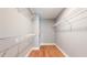 A walk-in closet with installed wire shelving and wood flooring at 1580 Commerce Dr # A8, Decatur, GA 30030