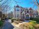 Street view of townhome featuring mature trees and landscaping surrounding building's facade at 1580 Commerce Dr # A8, Decatur, GA 30030