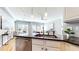 Bright kitchen with modern lighting, stainless steel appliances, and granite counters, opening to the living space at 1580 Commerce Dr # A8, Decatur, GA 30030