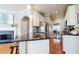 Modern kitchen featuring a breakfast bar, granite countertops, and stainless steel appliances with access to dining room at 1580 Commerce Dr # A8, Decatur, GA 30030