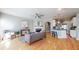 Open-concept living room showcasing a fireplace, hardwood floors, and seamless transition to the modern kitchen area at 1580 Commerce Dr # A8, Decatur, GA 30030