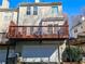 Rear view of a home featuring a two-story deck, a well-maintained yard, and an attached garage at 1580 Commerce Dr # A8, Decatur, GA 30030