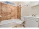 Bathroom with a tub and shower, tiled walls, toilet, sink and vanity with mirror at 1899 Lathrop Se St, Atlanta, GA 30315