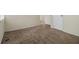 Spacious bedroom with neutral carpet, a window letting in natural light, and two closets at 1899 Lathrop Se St, Atlanta, GA 30315