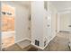 Hallway view with access to a bathroom with tiled floors and access to bedrooms with carpet at 1899 Lathrop Se St, Atlanta, GA 30315