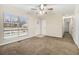 Bright living room with large window, ceiling fan, neutral carpet, and fresh paint at 1899 Lathrop Se St, Atlanta, GA 30315