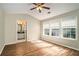 Bright bedroom with hardwood floors, ceiling fan, and ensuite bathroom at 2280 Whitestone Pl, Alpharetta, GA 30005