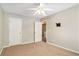 Neutral bedroom featuring plush carpeting and a ceiling fan; ample closet space at 2280 Whitestone Pl, Alpharetta, GA 30005
