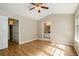 Bedroom with hardwood floors, ceiling fan, and view of ensuite bathroom at 2280 Whitestone Pl, Alpharetta, GA 30005