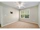 Neutral bedroom featuring plush carpeting, a ceiling fan, and a bright window with a wooded view at 2280 Whitestone Pl, Alpharetta, GA 30005