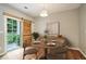 Charming dining room with a round table, stylish light fixture, and a sliding barn door at 2280 Whitestone Pl, Alpharetta, GA 30005