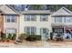 Inviting two-story townhome with light yellow siding and charming green shutters at 2280 Whitestone Pl, Alpharetta, GA 30005