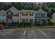 Exterior view of townhomes with street parking and well-manicured landscaping at 2280 Whitestone Pl, Alpharetta, GA 30005