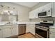Functional kitchen showcases white cabinets, stainless steel appliances, and wood-style flooring at 2280 Whitestone Pl, Alpharetta, GA 30005