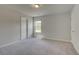 Bedroom with soft carpeting, a window, and closet doors with white trim at 30 Homesite Cooper E Cv, Fayetteville, GA 30215