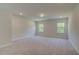 Spacious bedroom with neutral carpet, recessed lights, and bright windows overlooking the yard at 30 Homesite Cooper E Cv, Fayetteville, GA 30215