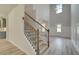 Inviting entryway boasts a staircase with stained wood and a view to the formal dining area at 30 Homesite Cooper E Cv, Fayetteville, GA 30215