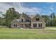 Charming two-story home features a lush green lawn and a welcoming brick and siding facade at 30 Homesite Cooper E Cv, Fayetteville, GA 30215