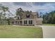 This two-story home features brick accents, neutral siding and an attached two car garage at 30 Homesite Cooper E Cv, Fayetteville, GA 30215