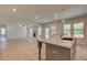 Open-concept living space with a kitchen island and a view of the living room at 30 Homesite Cooper E Cv, Fayetteville, GA 30215
