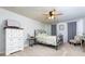 Bedroom with carpet floors, a ceiling fan, an iron bed frame and grey curtains at 4675 Dandelion Way, Cumming, GA 30040