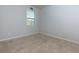 Bright bedroom with neutral carpet and a window allowing ample natural light at 4675 Dandelion Way, Cumming, GA 30040