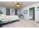 Bedroom with carpet floors, a ceiling fan, an iron bed frame and grey curtains at 4675 Dandelion Way, Cumming, GA 30040