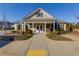 Community clubhouse featuring pedestrian walkway and mature landscaping at 4675 Dandelion Way, Cumming, GA 30040