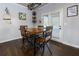 Cozy dining area features dark hardwood floors, a wooden table, and a door to the outside at 4675 Dandelion Way, Cumming, GA 30040