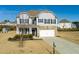 Charming two-story home with stone accents, a well-manicured lawn, and a two car garage at 4675 Dandelion Way, Cumming, GA 30040
