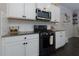 Close-up of a kitchen with white cabinets, granite countertops, and a stainless steel oven at 4675 Dandelion Way, Cumming, GA 30040