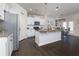 Modern kitchen with white cabinets, granite countertops, stainless steel appliances, and an island at 4675 Dandelion Way, Cumming, GA 30040