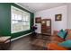 Cozy living room with hardwood floors, a large window, and comfortable seating arrangement at 4675 Dandelion Way, Cumming, GA 30040