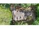 Overhead view of the home showing the roofline, treed surroundings, and driveway location at 90 Lakeside Dr, Hiram, GA 30141