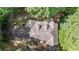 Aerial view of a charming home nestled among lush trees, showcasing its roof and outdoor spaces at 90 Lakeside Dr, Hiram, GA 30141