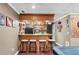 Entertainment basement featuring a classic bar with stools and overhead shelving at 90 Lakeside Dr, Hiram, GA 30141