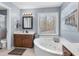 Bathroom with a soaking tub, large window, and separate shower at 90 Lakeside Dr, Hiram, GA 30141