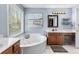 Bright bathroom with a jacuzzi tub, a large window, and vanity at 90 Lakeside Dr, Hiram, GA 30141