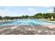 Large swimming pool with lounge chairs along the side, surrounded by a fence and trees at 90 Lakeside Dr, Hiram, GA 30141