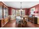 Formal dining room with an ornate china cabinet, hardwood floors, and natural light at 90 Lakeside Dr, Hiram, GA 30141