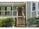 Inviting front porch with a wooden door and a charming wreath, surrounded by lush greenery at 90 Lakeside Dr, Hiram, GA 30141