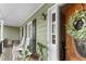 Cozy front porch featuring rocking chairs, a swing, and a lovely view, perfect for relaxation at 90 Lakeside Dr, Hiram, GA 30141
