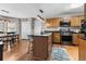 Well-lit kitchen with an island, wooden cabinets, and stainless steel appliances at 90 Lakeside Dr, Hiram, GA 30141
