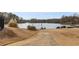 Community area with a lake and a paved walkway leading to the water at 90 Lakeside Dr, Hiram, GA 30141