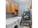 Efficient laundry room with washer, dryer, storage cabinets and shelving for organization at 90 Lakeside Dr, Hiram, GA 30141