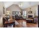 Spacious living room with hardwood floors, vaulted ceiling, and fireplace at 90 Lakeside Dr, Hiram, GA 30141