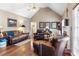 Cozy living room features a fireplace, vaulted ceilings, and lots of light at 90 Lakeside Dr, Hiram, GA 30141