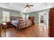 Spacious main bedroom with tray ceilings, hardwood floors, and ensuite bathroom at 90 Lakeside Dr, Hiram, GA 30141