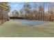 Outdoor tennis court with a green surround, black fencing, and a bench to sit on at 90 Lakeside Dr, Hiram, GA 30141